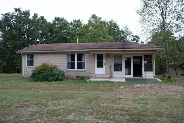 single story home with brick siding and a front lawn
