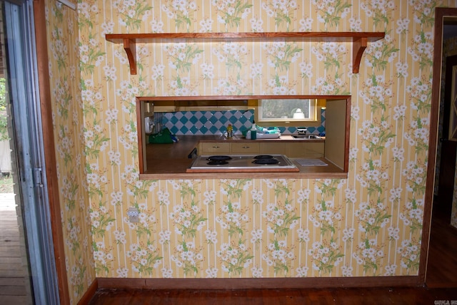interior details featuring baseboards and wallpapered walls