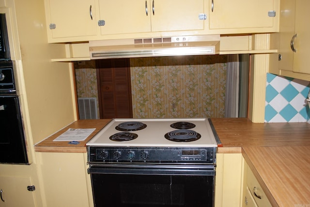 kitchen featuring decorative backsplash, visible vents, under cabinet range hood, black oven, and electric range