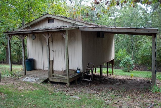 view of outdoor structure featuring an outbuilding and a forest view