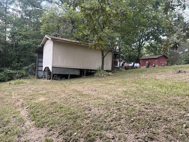 view of property exterior featuring an outbuilding and a lawn