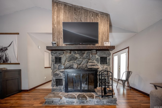 room details featuring wood-type flooring, french doors, and a fireplace