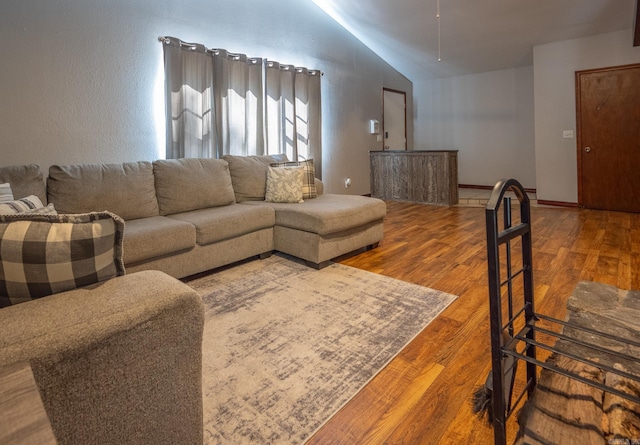 living room featuring hardwood / wood-style flooring and lofted ceiling