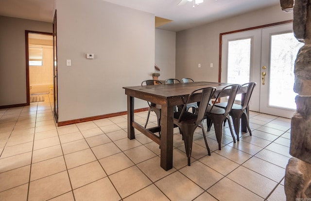 dining room featuring ceiling fan, french doors, and light tile patterned flooring