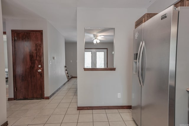 kitchen with stainless steel fridge, ceiling fan, and light tile patterned floors