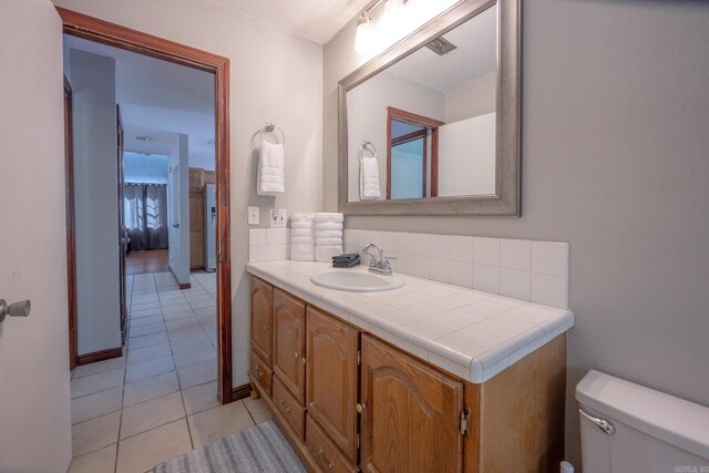 bathroom featuring tile patterned floors, vanity, and toilet