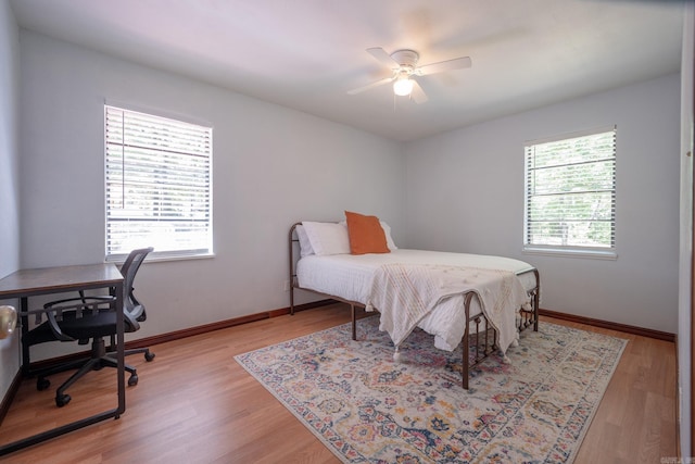 bedroom with ceiling fan and light hardwood / wood-style floors