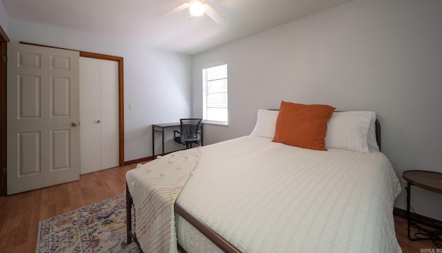 bedroom with ceiling fan, wood-type flooring, and a closet