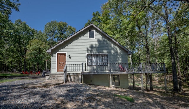 rear view of property with a wooden deck