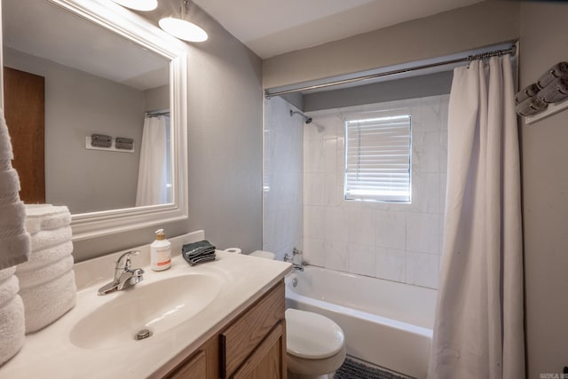 full bathroom with vanity, shower / tub combo, and toilet