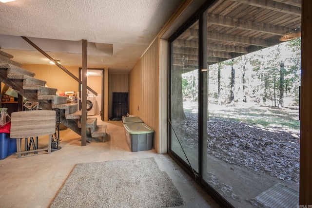 interior space featuring a textured ceiling and concrete flooring