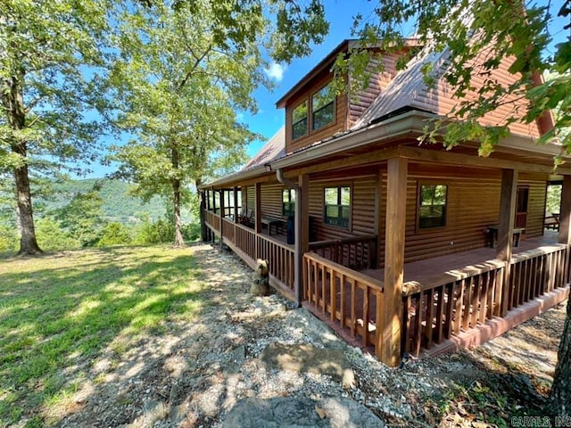 view of side of home with a lawn