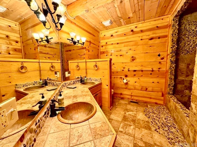 bathroom with wood ceiling, wooden walls, tile patterned flooring, and vanity