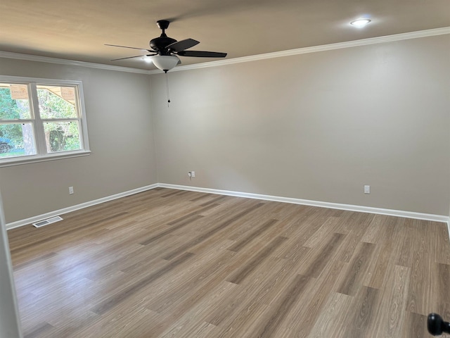 empty room featuring crown molding, light hardwood / wood-style flooring, and ceiling fan