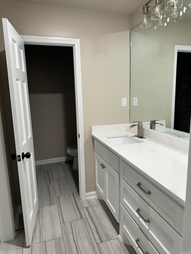 bathroom with vanity and toilet