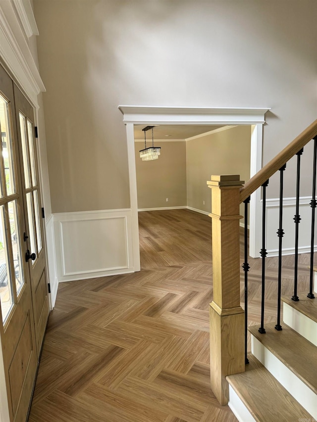 entryway featuring an inviting chandelier and parquet flooring