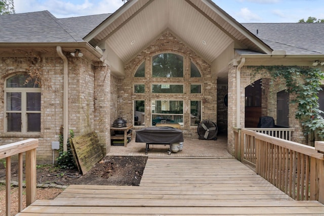 wooden deck featuring a grill