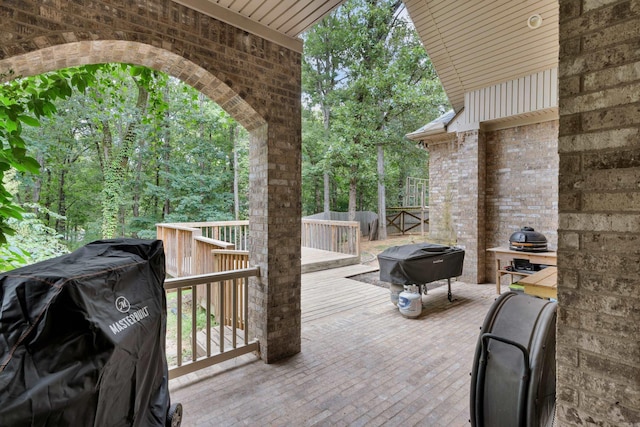 wooden deck featuring a grill