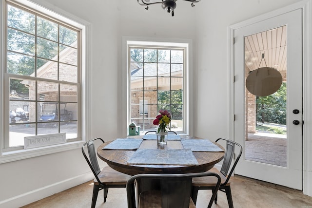 dining space with a wealth of natural light and light colored carpet