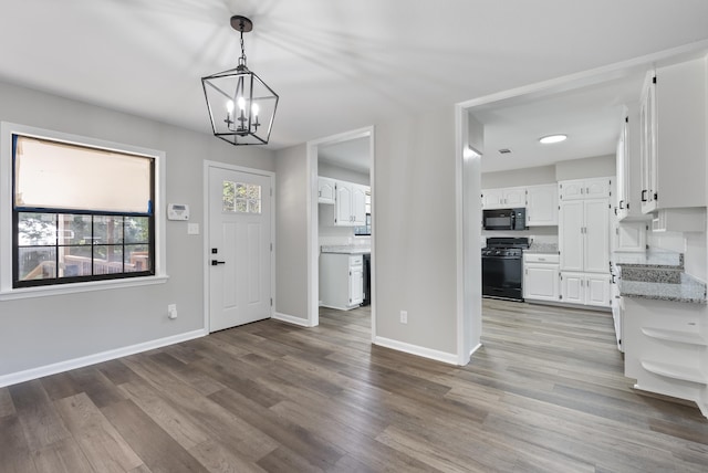 entryway with light wood-type flooring, baseboards, and a chandelier