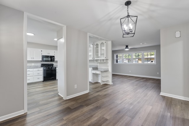 unfurnished dining area featuring baseboards and wood finished floors