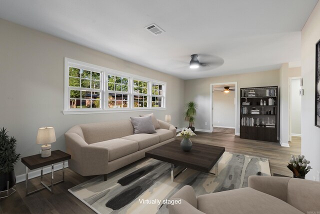 kitchen with sink, wood-type flooring, light stone counters, black appliances, and white cabinets