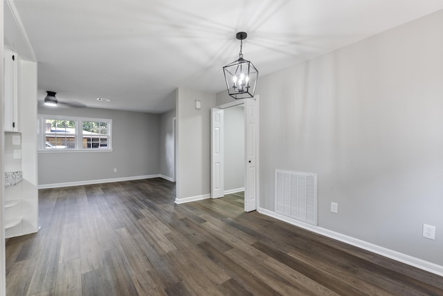 unfurnished dining area with baseboards, visible vents, and dark wood-type flooring