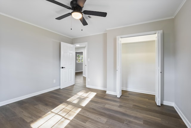 unfurnished bedroom featuring ornamental molding, dark wood-style flooring, and baseboards