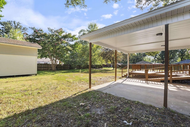 view of yard with a patio area, a wooden deck, and fence