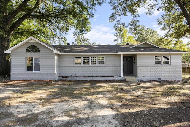 ranch-style home featuring brick siding and crawl space