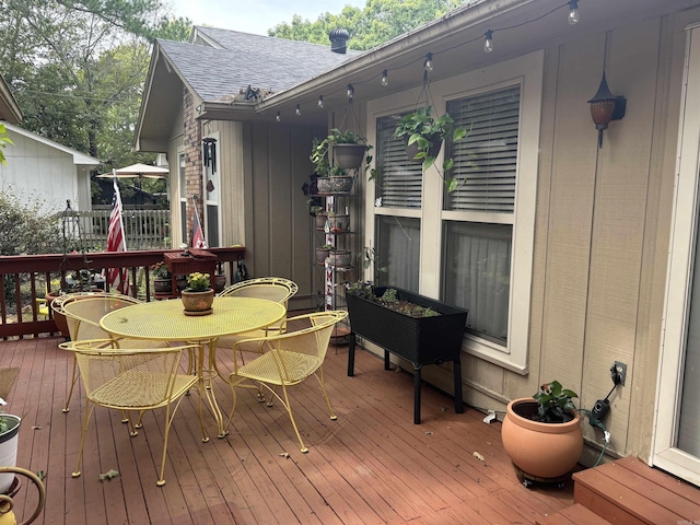 wooden deck featuring outdoor dining space