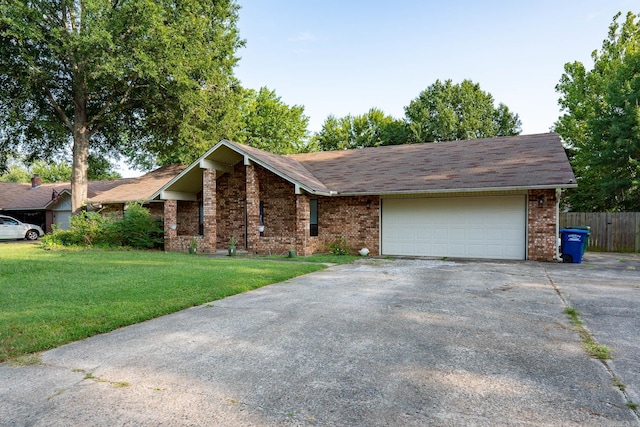 view of front of property with driveway, an attached garage, a front lawn, and brick siding