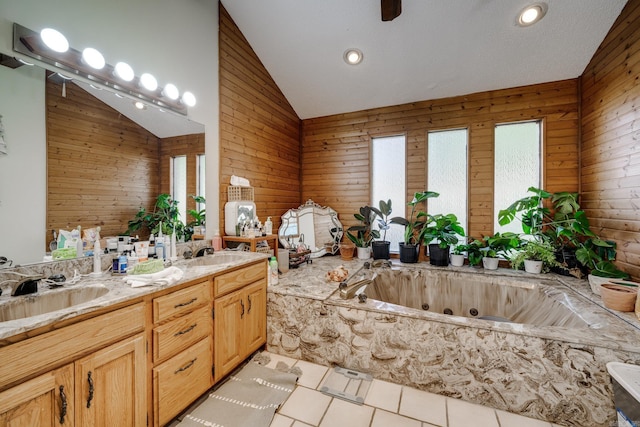 bathroom featuring a whirlpool tub, double vanity, a sink, and tile patterned floors