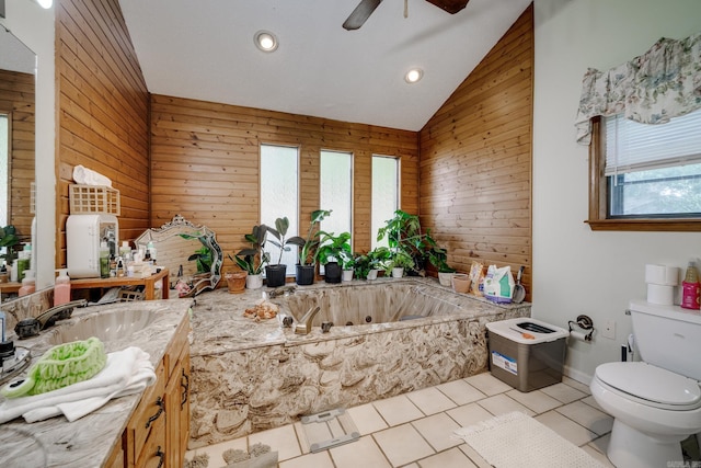 bathroom with toilet, vaulted ceiling, wooden walls, tile patterned flooring, and a tub with jets