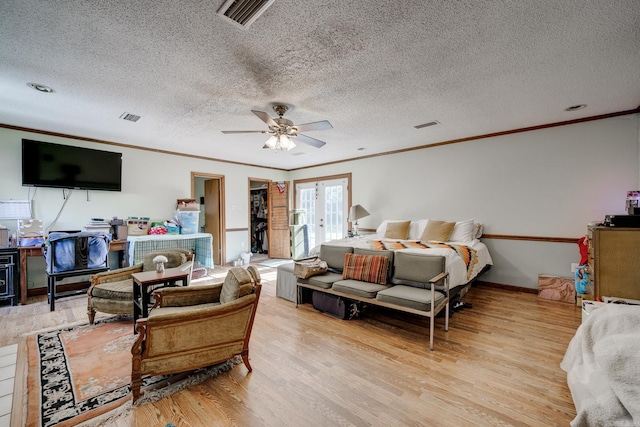 bedroom featuring french doors, light wood-type flooring, and visible vents