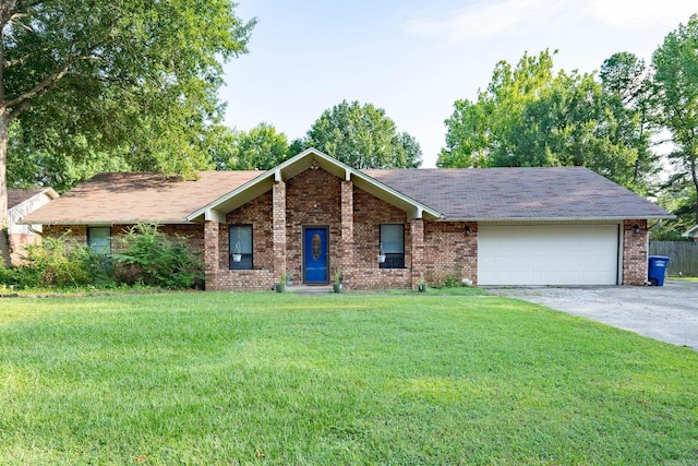 view of front of property with driveway, brick siding, a front lawn, and an attached garage