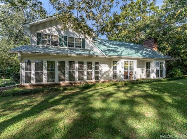 rear view of house with a yard