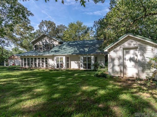 rear view of house with a yard