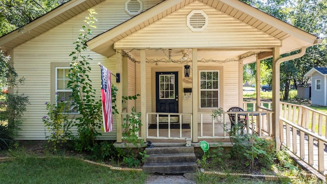 view of exterior entry with covered porch