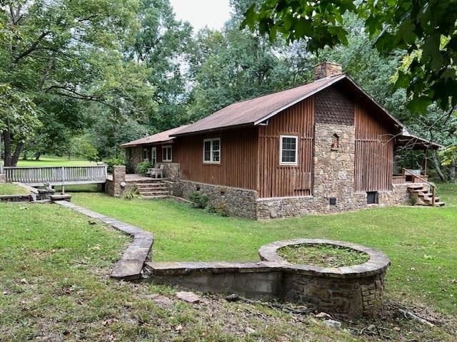 view of side of home featuring a yard