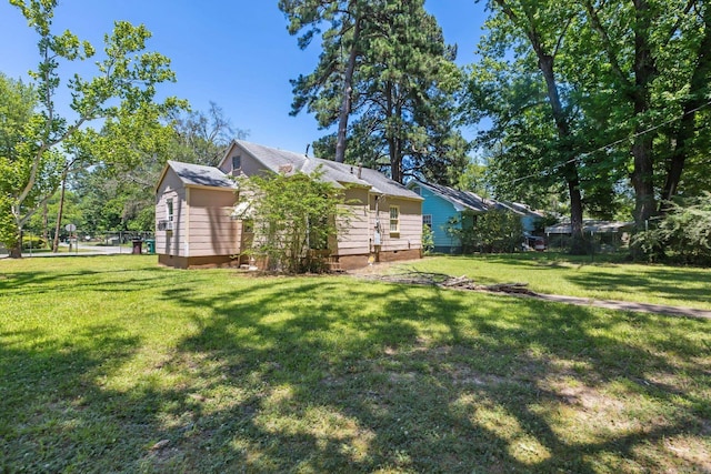 view of side of home with a lawn