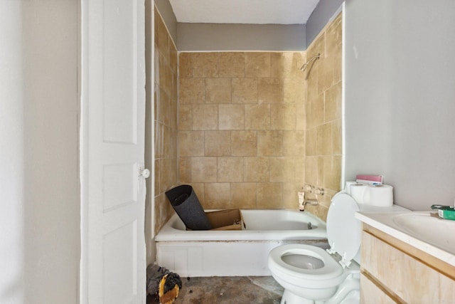 full bathroom featuring tiled shower / bath, vanity, and toilet