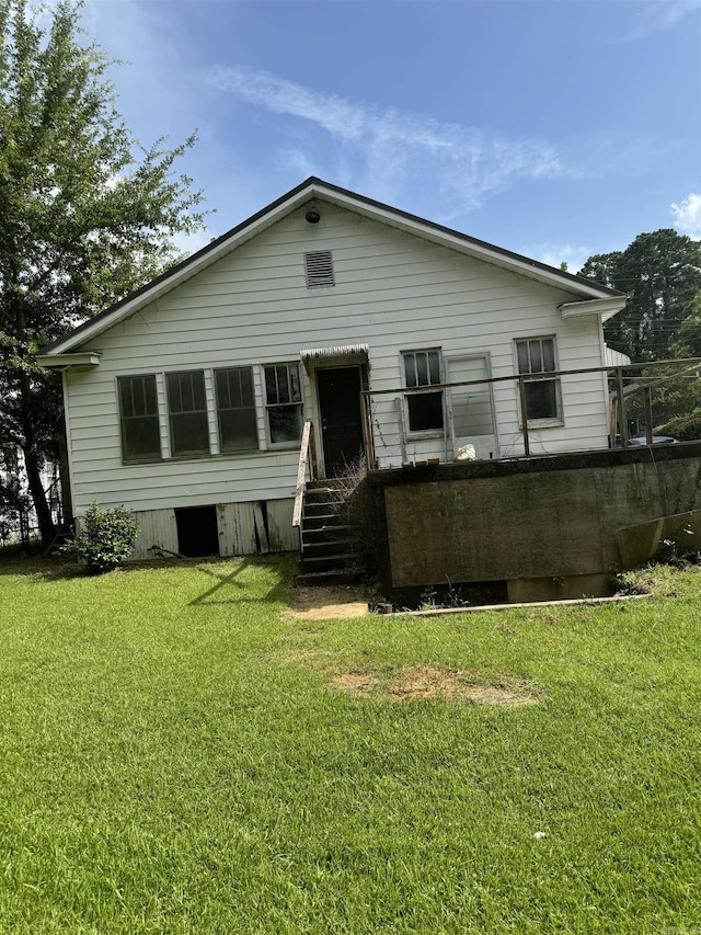 back of property featuring a lawn