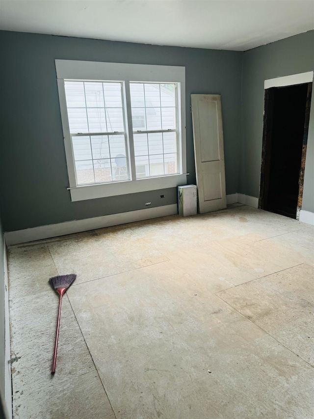 spare room featuring baseboards