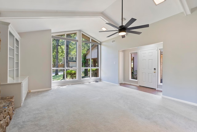 interior space with ceiling fan, beam ceiling, high vaulted ceiling, and light colored carpet