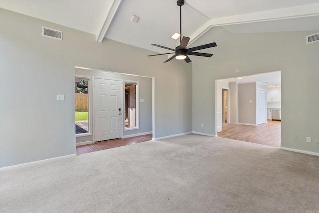 empty room featuring ceiling fan, light wood-type flooring, high vaulted ceiling, and beam ceiling