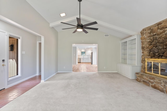 unfurnished living room featuring ceiling fan, vaulted ceiling, light colored carpet, and a fireplace