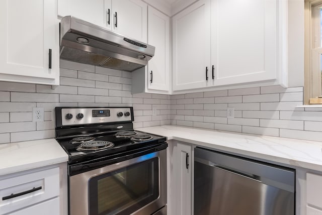 kitchen featuring appliances with stainless steel finishes, light stone countertops, decorative backsplash, and white cabinets