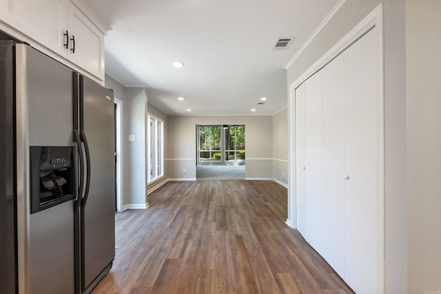 hall featuring crown molding and dark wood-type flooring