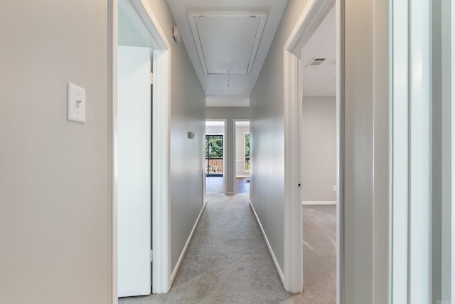 hallway with light colored carpet